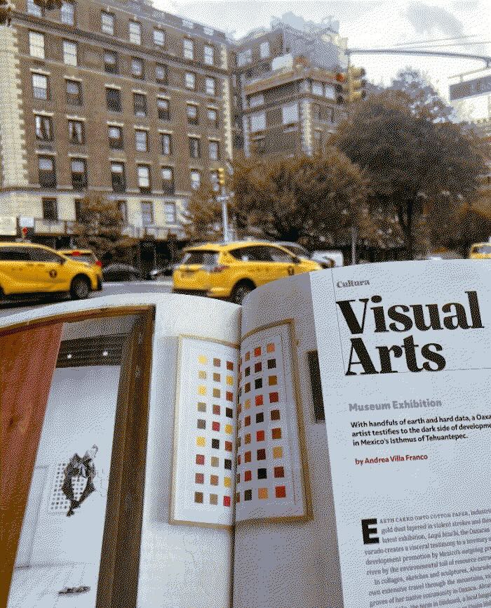 Americas Quarterly magazine open in the foreground and in the background a busy NYC street.