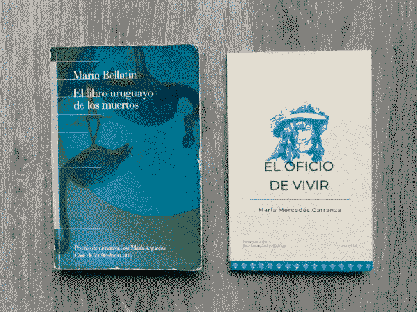 Two books on a grey wood background. On the left El libro uruguayo de los muertos and on the right El oficio de vivir.