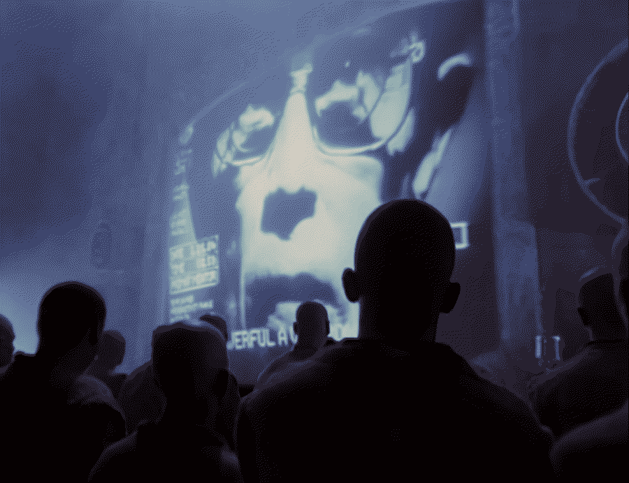 Audience listening to man talking on the screen.